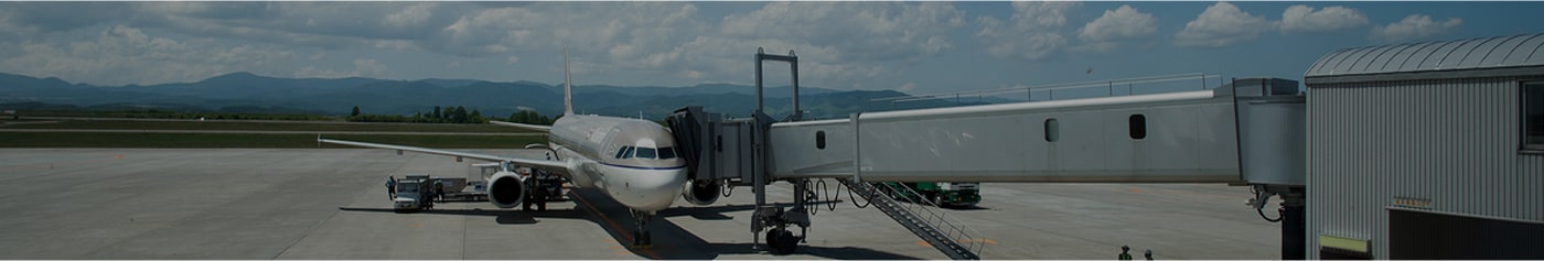 An airplane connected to a boarding bridge before departure.